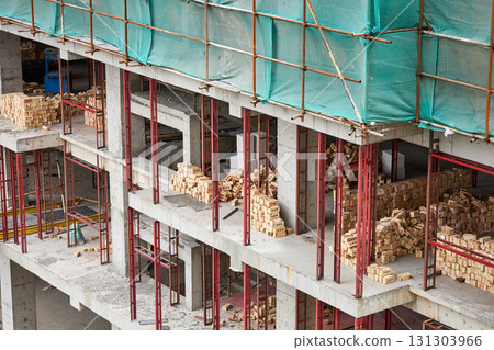 A construction site for an apartment building. Piles of bricks 131303966