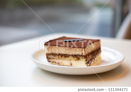Square Tiramisu served on plate in the cafe 131304271