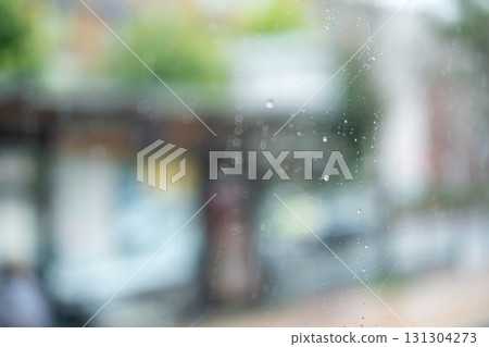 Rain drops on the bus glass, with blurred background Rain drops on the bus glass, with blurred background 131304273