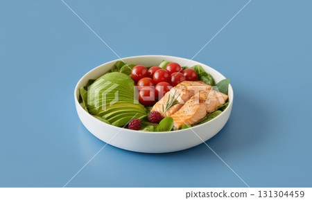Fresh salmon and avocado salad with cherry tomatoes and spinach in a white bowl 131304459