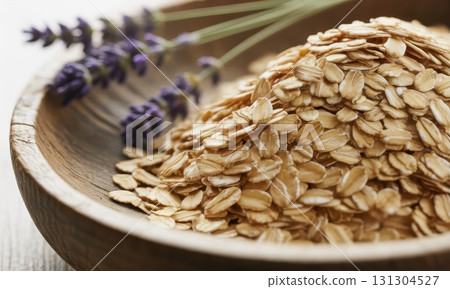 Close up of rolled oats and fresh lavender in a rustic wooden bowl for healthy breakfast Close up of rolled oats and fresh lavender in a rustic wooden bowl for healthy breakfast 131304527