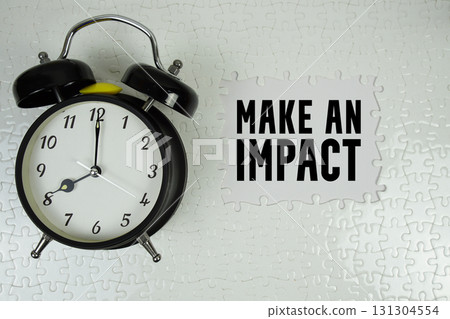 Make An Impact text with alarm clock on white background Make An Impact text with alarm clock on white background 131304554