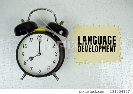 Language Development text with alarm clock on yellow background 131304557