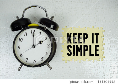 Keep It Simple text with alarm clock on yellow background Keep It Simple text with alarm clock on yellow background 131304558