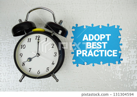Adopt Best Practice text with alarm clock on blue background 131304594