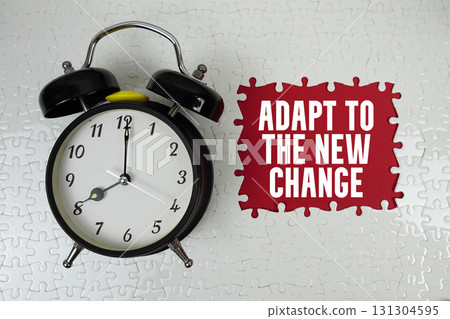 Adapt To The New Change text with alarm clock on red background 131304595