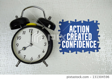 Action Created Confidence text with alarm clock on navy blue background Action Created Confidence text with alarm clock on navy blue background 131304596