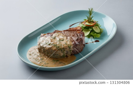 Juicy grilled steak generously covered in creamy mushroom sauce with fresh herbs and a side salad 131304806