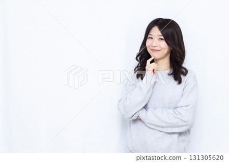 Woman thinking with a smile Woman thinking with a smile 131305620