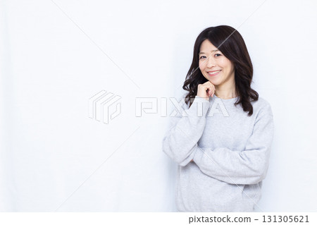 Woman thinking with a smile Woman thinking with a smile 131305621