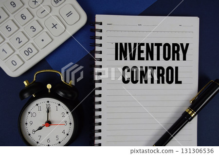 Inventory Control text written on notepad with calculator and alarm clock on navy blue background Inventory Control text written on notepad with calculator and alarm clock on navy blue background 131306536