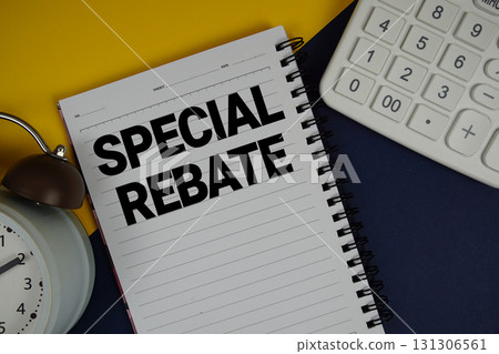 Special Rebate text written on notepad with calculator and alarm clock on navy blue background Special Rebate text written on notepad with calculator and alarm clock on navy blue background 131306561