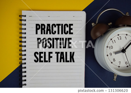 Practice Positive Self Talk text written on notepad with alarm clock on yellow background 131306620