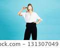 Studio portrait of woman with magnifying glass 131307049