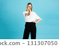 Studio portrait of woman with magnifying glass 131307050