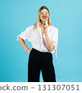 Studio portrait of woman with magnifying glass 131307051