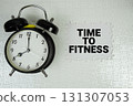 Time To Fitness text with alarm clock on white background 131307053