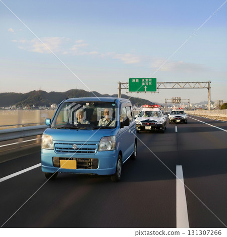 AI-generated image (a light vehicle driven by an elderly man who is unaware that he is being chased by a police car for violating a lane) 131307266