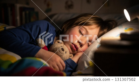 Child asleep with a book in bed. 131307502