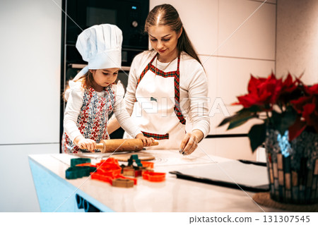 A joyful baking session filled with laughter, creativity, and love between a mother and daughter in the kitchen 131307545
