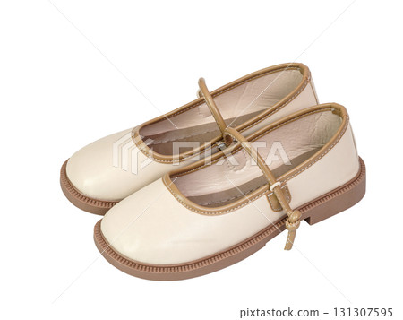 Cream shoes with brown trim and strap featuring classic round toe and sturdy sole isolated on white background Cream shoes with brown trim and strap featuring classic round toe and sturdy sole isolated on white background 131307595