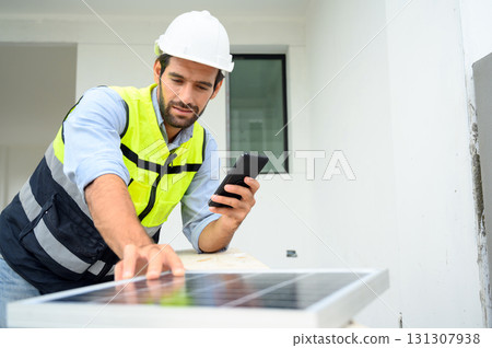 electrician man in safety vest with helmet use smartphone for check solar cell plant. Green energy electricity. concept of sustainable resources. electrician man in safety vest with helmet use smartphone for check solar cell plant. Green energy electricity. concept of sustainable resources. 131307938