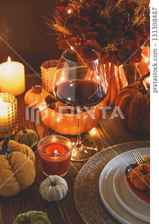 Autumnal table setting with decorative pumpkins, candles and string lights. Autumnal table setting with decorative pumpkins, candles and string lights. 131308487