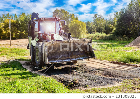 Precision ground shaping front end loader creates optimal conditions for construction foundation laying. 131309323