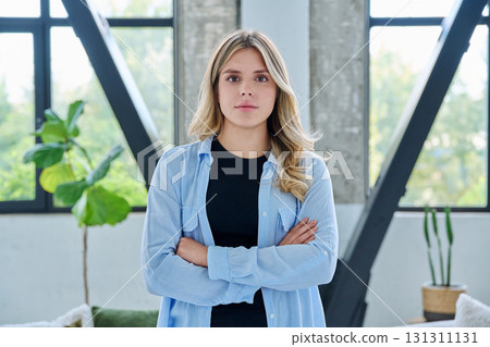Portrait of young confident smiling woman in home interior 131311131