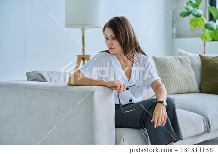 Mature sad woman experiencing stress, mental and physical pain, at home Mature sad woman experiencing stress, mental and physical pain, at home 131311138