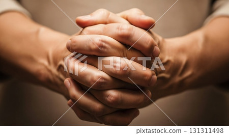 Clasped hands show prayer and devotion. 131311498
