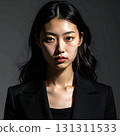 A portrait exuding elegance, with a strong gaze that stands out against sharp shadows 131311533