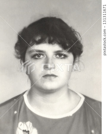 A vintage portrait of a twenty-year-old girl with unconventional makeup. Retro photo from 1987. 131311671