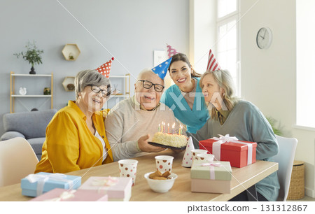 Senior people Happy Birthday party with cake for elderly with nurse, caregiver, support worker 131312867