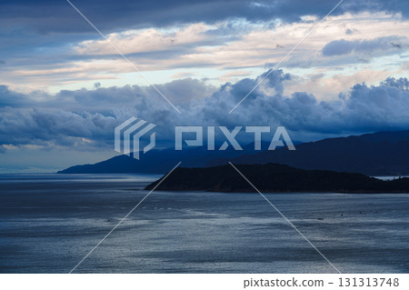 Early morning clouds cleared and visibility improved across the Wakayama Kitan Strait. Cumulus clouds floating above Awaji Island. Early morning clouds cleared and visibility improved across the Wakayama Kitan Strait. Cumulus clouds floating above Awaji Island. 131313748