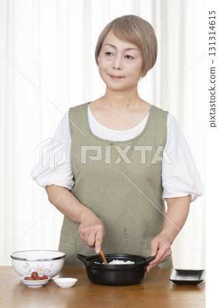 Senior woman making rice balls in the kitchen 131314615