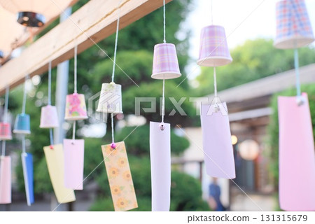 A row of handmade wind chimes at a summer festival A row of handmade wind chimes at a summer festival 131315679