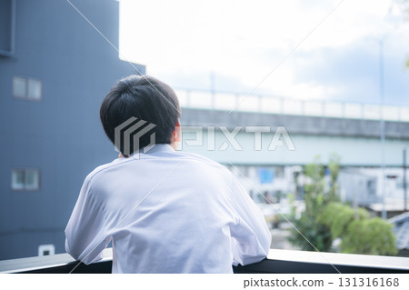 A boy looking up at the sky and thinking about exams, the future and his future 131316168