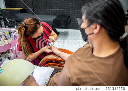 Nail technician manicure or pedicure at nail salon Nail technician manicure or pedicure at nail salon 131316250
