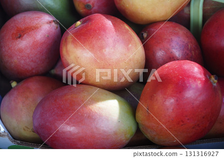 Fresh mangoes displayed at a local market in summer Fresh mangoes displayed at a local market in summer 131316927