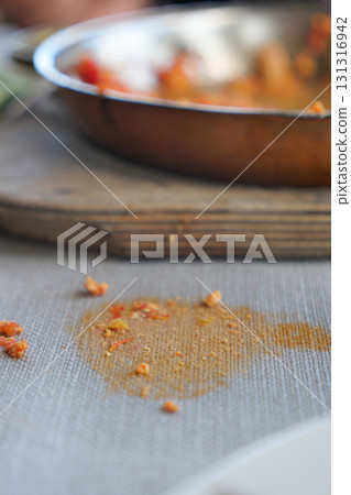Food crumbs and stains on a rustic cloth table 131316942