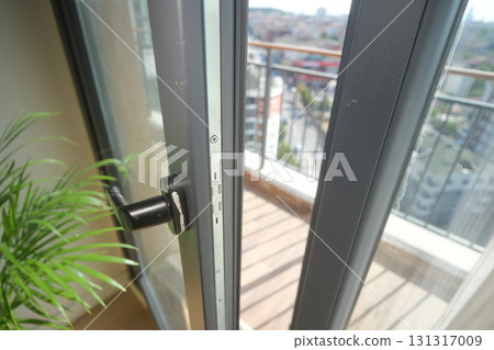 View from a balcony with doors open to city scenery View from a balcony with doors open to city scenery 131317009