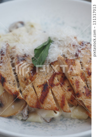 Grilled chicken with creamy pasta and herbs on a plate Grilled chicken with creamy pasta and herbs on a plate 131317013