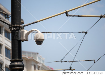 Surveillance camera on a street with overhead wires 131317130