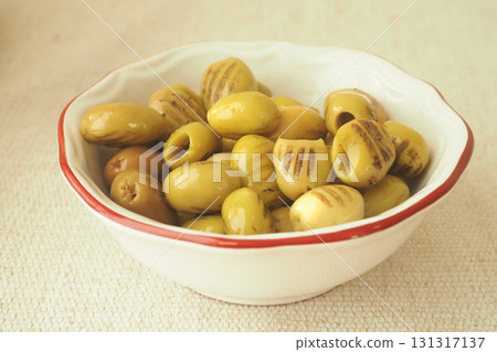 Variety of green olives in a decorative bowl 131317137