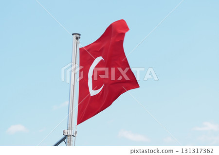 Turkish flag waving against a clear blue sky Turkish flag waving against a clear blue sky 131317362