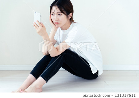 A woman using a smartphone A woman using a smartphone 131317611