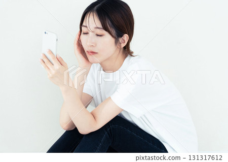 A woman using a smartphone A woman using a smartphone 131317612