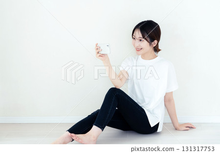 A woman using a smartphone 131317753