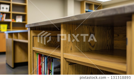 Empty wooden bookshelves with countertop in library 131318893